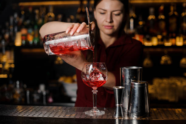 istock Bartender girl making a fresh light red cocktail 938154852