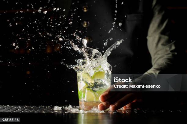 Cocktail Splash With Ice Cubes And Lime Stock Photo - Download Image Now - Cocktail, Bartender, Drink