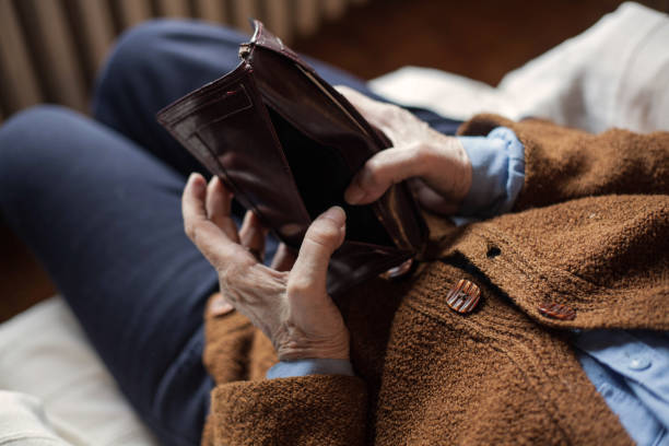 Pensioner. Old empty wallet in the hands .Vintage empty purse in hands of women . Poverty concept. empty pockets stock pictures, royalty-free photos & images