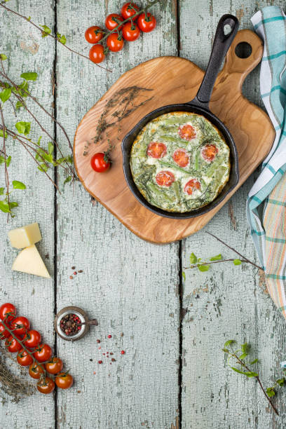 classic omelet with cherry tomatoes, cheese and herbs