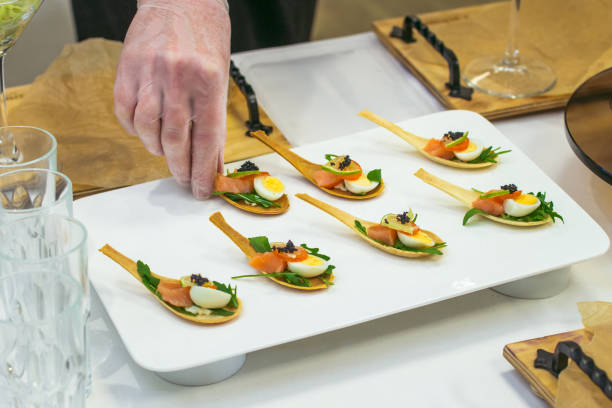 istock Delicates, appetizer filling with red fish, quail egg, black caviar and lime. Catering service during table decoration. 938162884