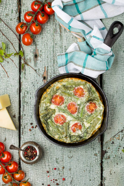 classic omelet with cherry tomatoes, cheese and herbs