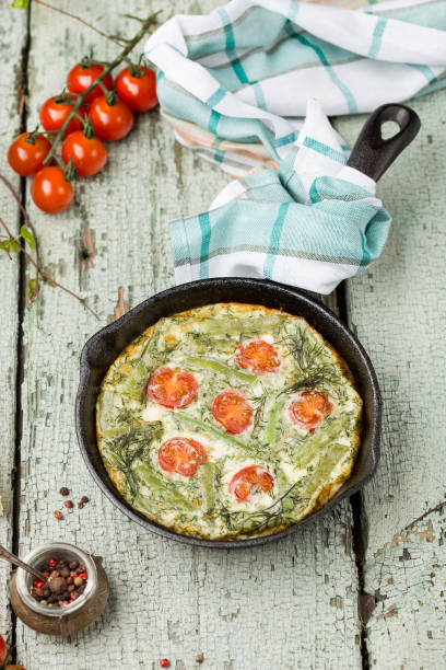 classic omelet with cherry tomatoes, cheese and herbs
