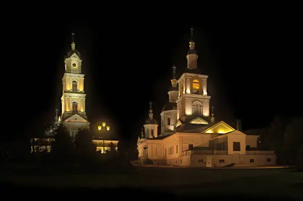 The light shines in the darkness. Kazan Cathedral and the bell tower of St. Seraphim of Sarov (Diveevo, Russia) of the monastery at night