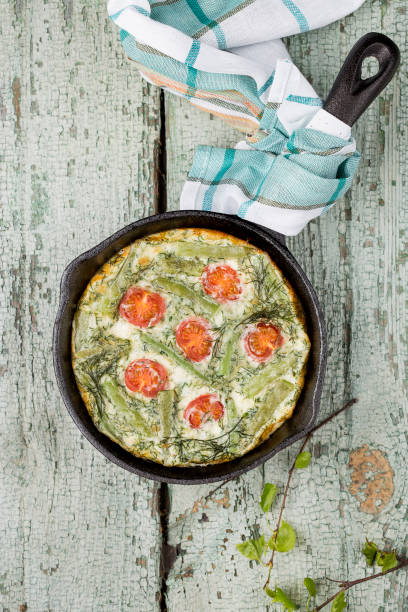 classic omelet with cherry tomatoes, cheese and herbs