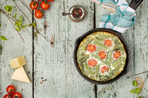 classic omelet with cherry tomatoes, cheese and herbs