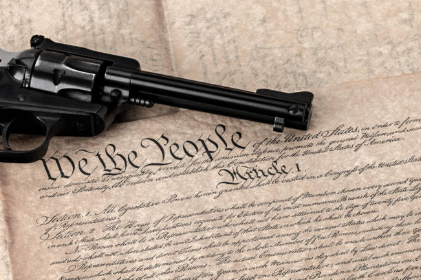 istock Handgun on a copy of the constitution in original font 938167580