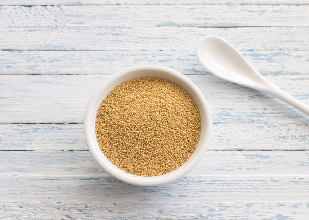 istock Raw amaranth seeds in a ceramic bowl on a light blue background 938170108