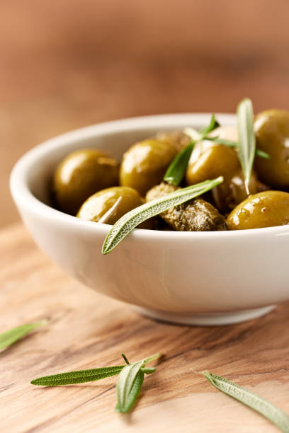 istock Pickled green olives and gherkins. Close up. Horizontal. 938170162