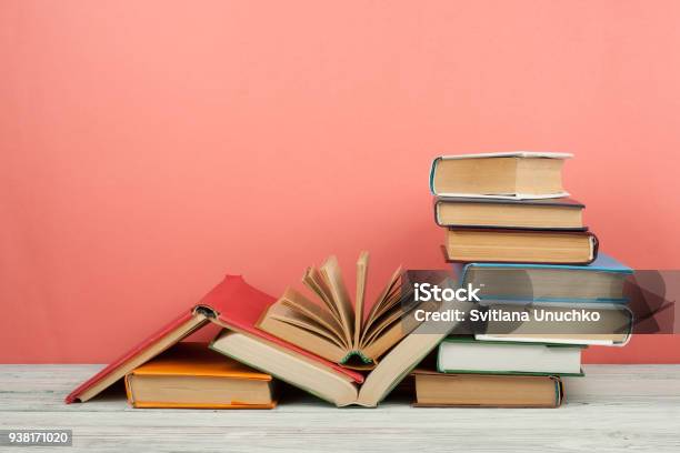 Book Stacking Open Book Hardback Books On Wooden Table And Pink Background Back To School Copy Space For Text Stock Photo - Download Image Now