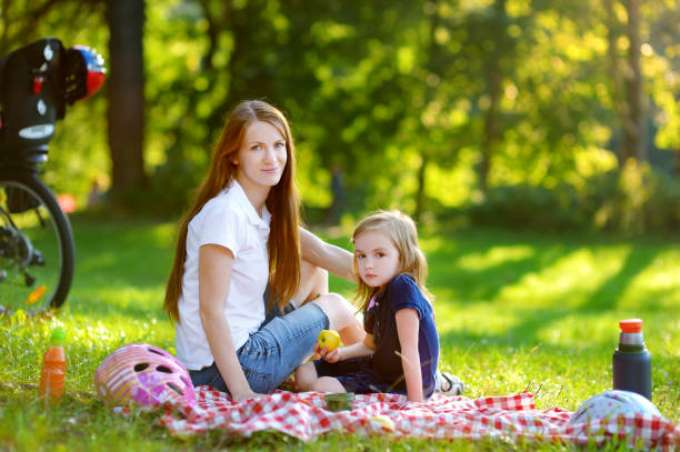 istock Young mother and her daughter picnicking 938179180