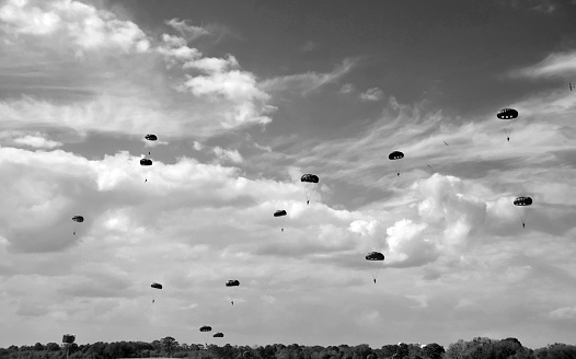 World War II era parachute drop in black and white