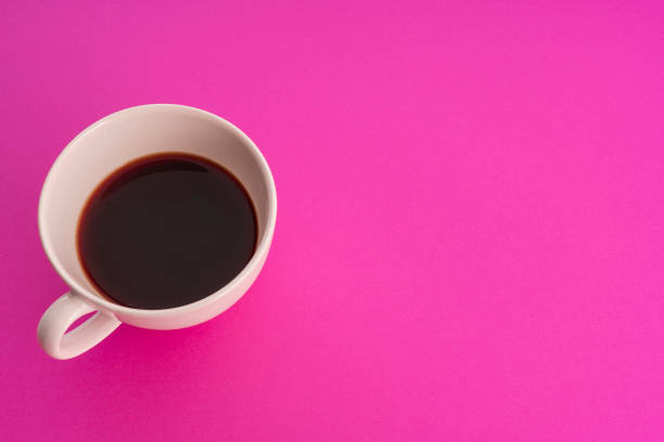 istock Cup of coffee on pink background 938184788