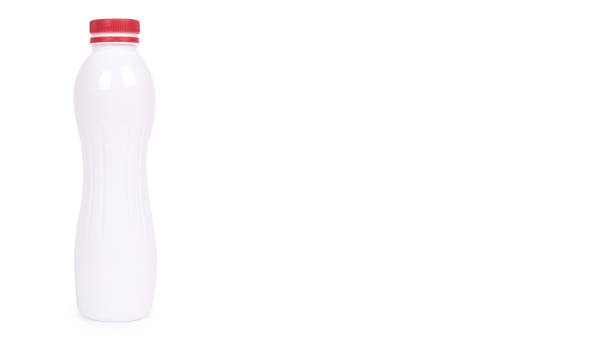 istock bottle of yoghurt with a red cap isolated on white background. copy space, template 938185472