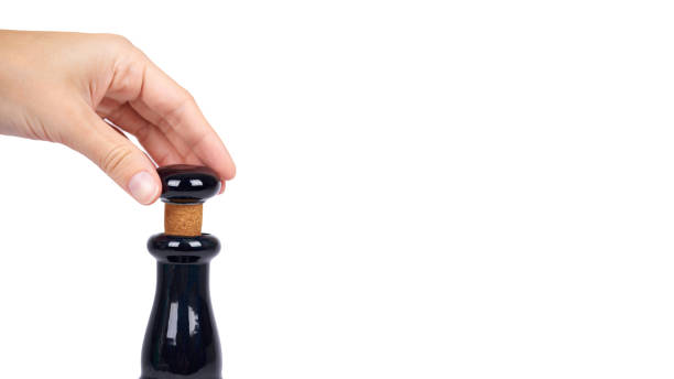 istock Beautiful black bottle in hand isolated on white background, expensive alcohol, luxury drink. copy space, template 938185478