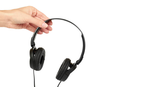 istock Black headphones in hand isolated on white background. copy space, template 938186048