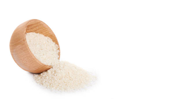istock raw Jasmine rice in wooden pot isolated on white background. copy space, template 938186220