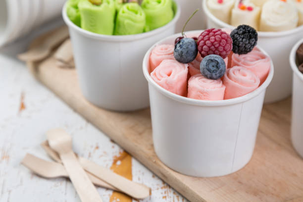 Selection of different rolled ice creams in cone cups stock photo