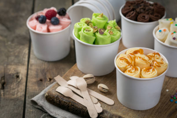 istock Selection of different rolled ice creams in cone cups 938186570