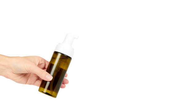 istock Plastic spray bottle with pump in hand isolated on white background. Foam dispenser for face care. Container with body lotion. copy space, template. 938186780