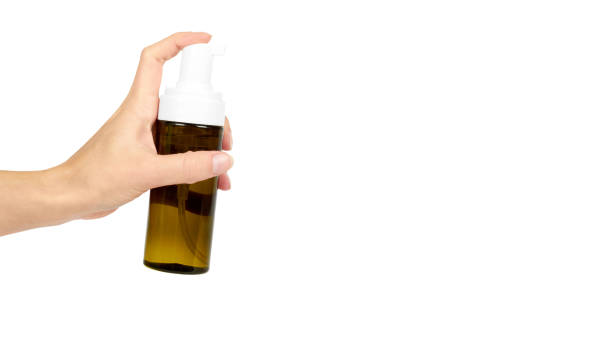istock Plastic spray bottle with pump in hand isolated on white background. Foam dispenser for face care. Container with body lotion. copy space, template. 938186816