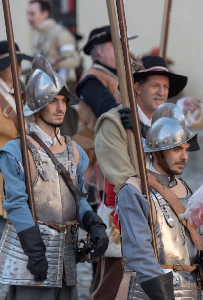 Medieval costume party Taggia, Italy - March 17, 2018: Participants of medieval costume party in the historic city of Taggia in Liguria region of Italy. The actors acting out episodes of daily life in settings that evoke moments of life lived fully the seventeenth century. The episodes depicted are inspired by true events, drawn from documents preserved in the Historical Archives rifle old fashioned antique ancient stock pictures, royalty-free photos & images