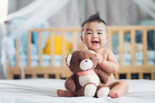 Photo of Asian baby sit with teddy bear