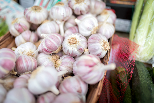 Fresh and organic garlic cloves close up on a farmers market stall in the England, UK