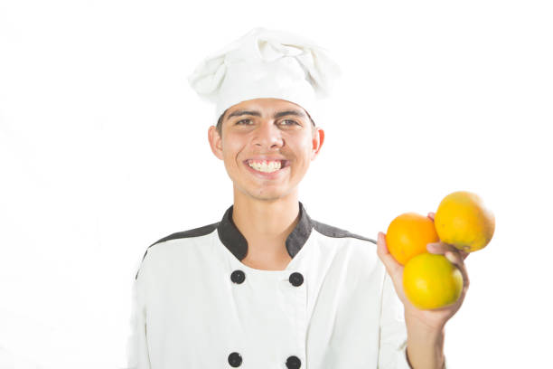 istock Young Chef Close-up Portrait with Fruits in Hands 938198788