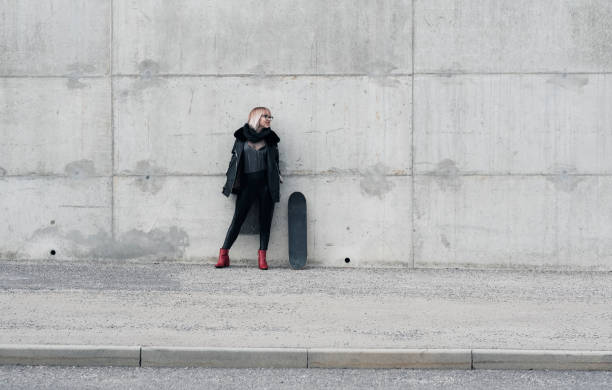 istock Young fashionable woman with skateboard 938199582