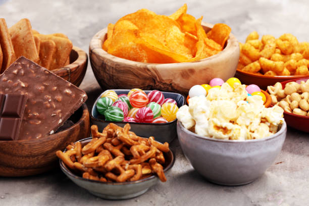 istock Salty snacks. Pretzels, chips, crackers in wooden bowls. 938203356
