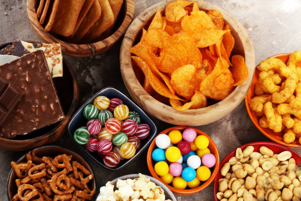 istock Salty snacks. Pretzels, chips, crackers in wooden bowls. 938204494
