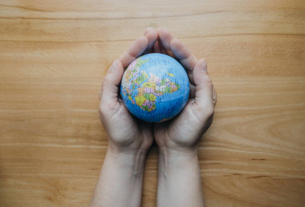 istock Globe in  woman hands, top view 938205580