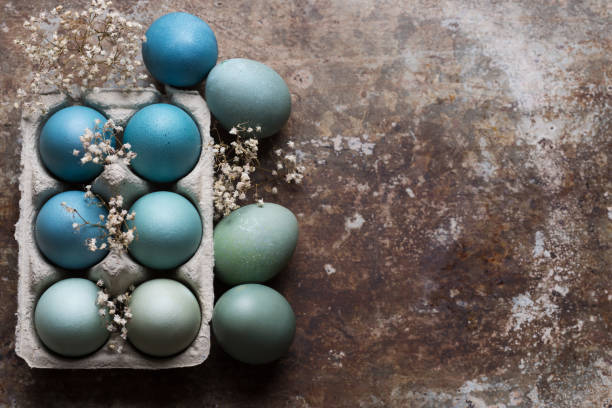 istock Happy Easter rustic concept with copy space. DIY dyed various shades of blue Easter eggs on retro rusty metal background. 938209590