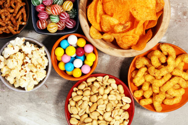 istock Salty snacks. Pretzels, chips, crackers in wooden bowls. 938210130