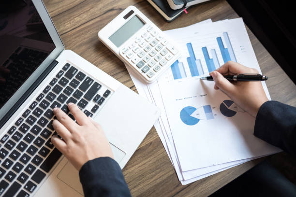 istock Professional business woman working with calculator, Doing finance on laptop, document graph and analysis business strategy to development profit 938210888