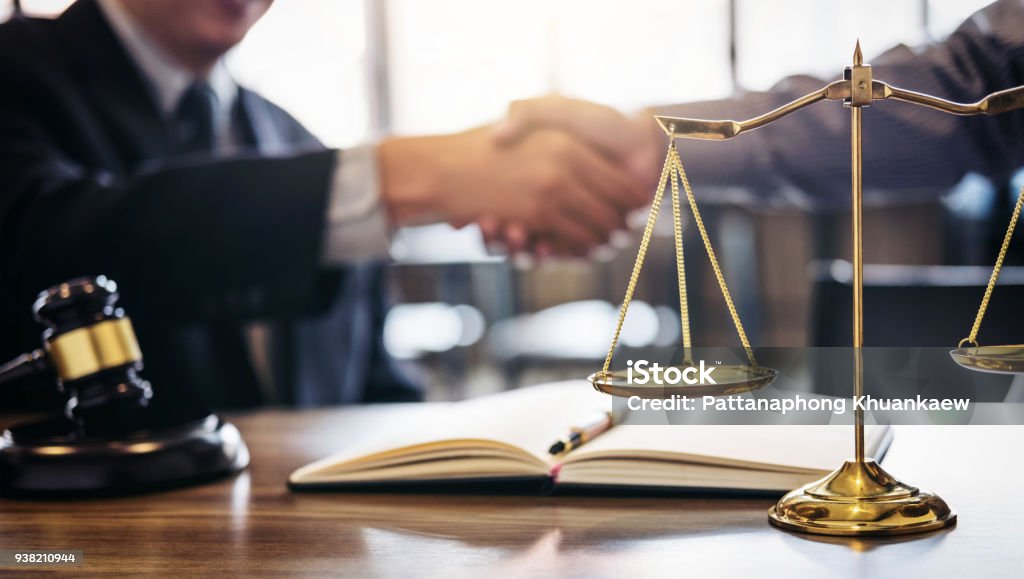 Handshake after good cooperation, Consultation between a male lawyer and businessman customer, tax and the company of real estate concept Handshake after good cooperation, Consultation between a male lawyer and businessman customer, tax and the company of real estate concept. Lawyer Stock Photo