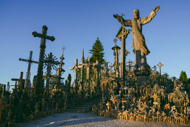 istock Statue And Cross At Cemetery Against Clear Sky 938215148