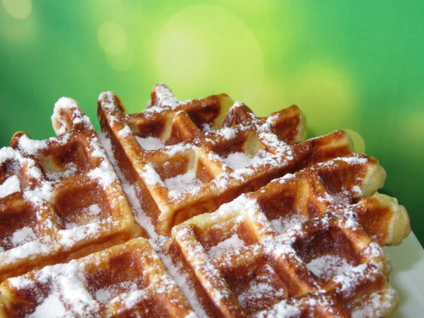 istock Belgian waffles on a green blurred background 938218958