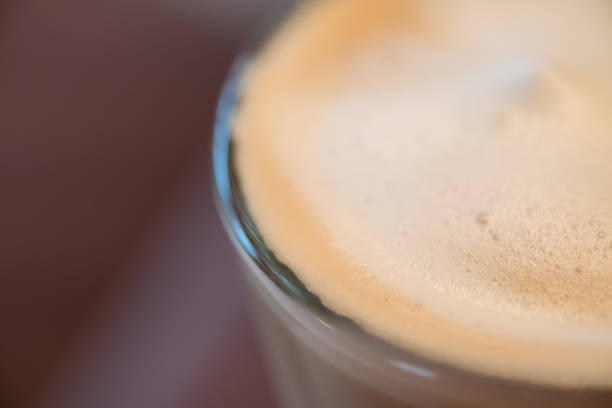 Close up of cup of hot coffee latte with milk foam.