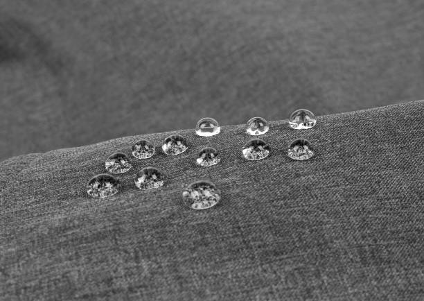 Photo of Gray waterproof fabric with waterdrops close-up