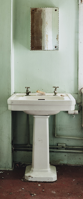 Retro styled bathroom inside an abandoned home.