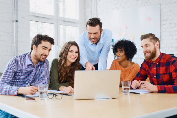 istock Creative agency coworkers discussing new project on laptop 938226546