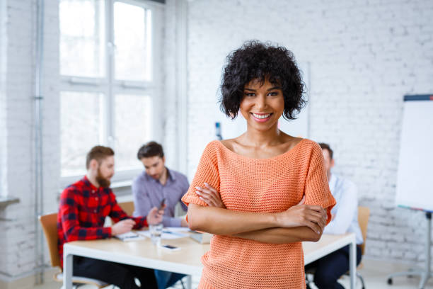 istock Happy female student standing at university classroom 938229898
