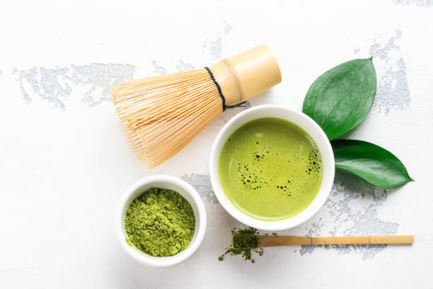 istock Green matcha tea drink and tea accessories on white background 938233998