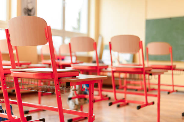 istock Empty classroom with school desks, chairs and blackboard. Education concept. 938234426