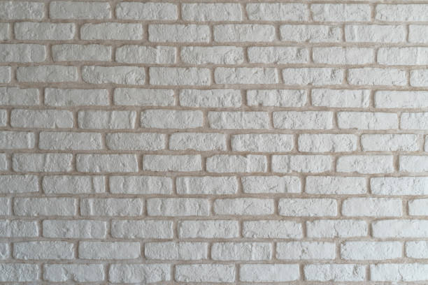 istock A wall of decorative brick with white plaster 938234854