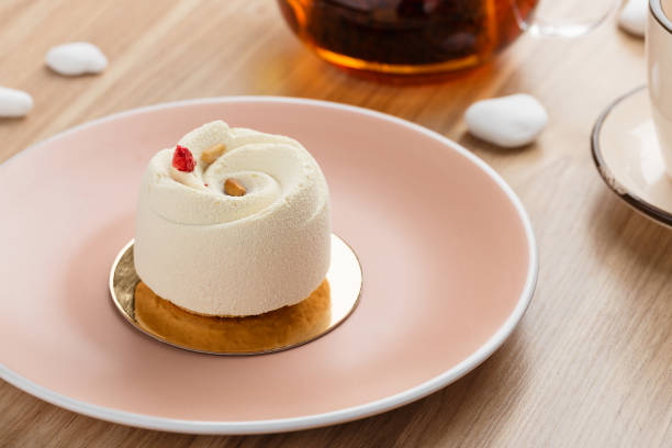 istock Mini mousse pastry dessert covered with white chocolate velour 938242340