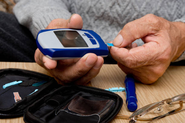 istock Concept diabetes in the elderly retired. Senior man with glucometer checking blood sugar level at home. Learn to use a glucometer 938242440