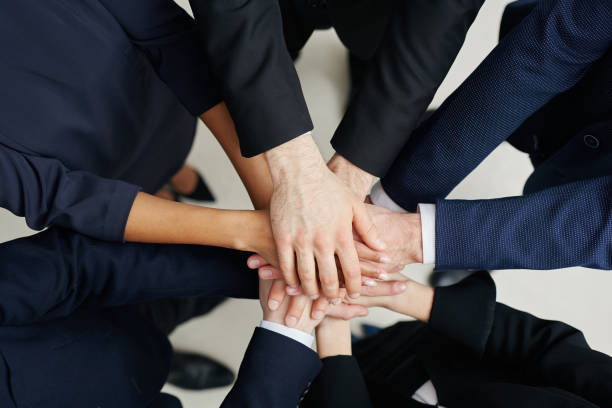 istock Bonding and teamwork concept - Businesspeople joining hands 938242982